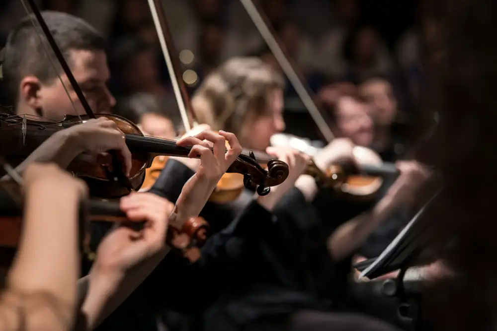 Violinists of a chamber orchestra playing in concert